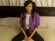 Asian girl with pigtails stripping on the bed